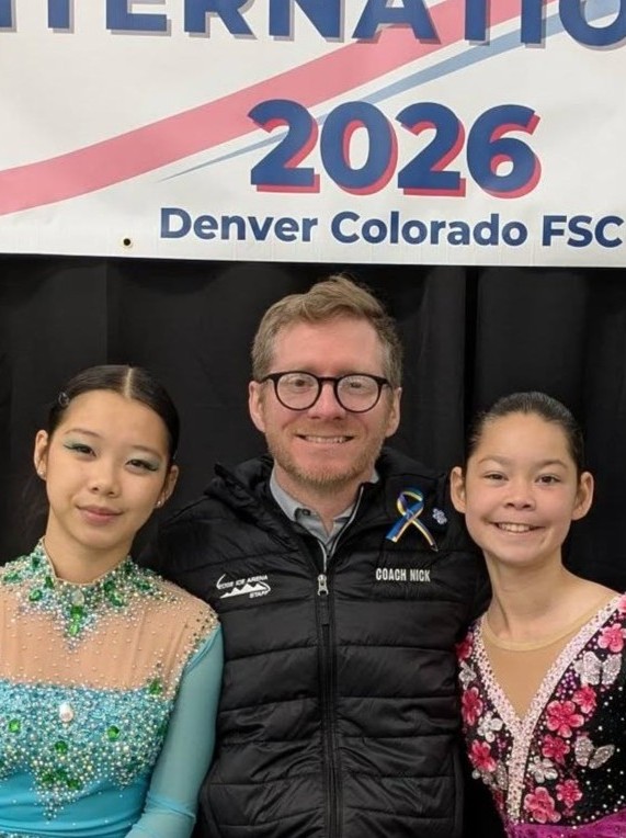 Coach Nick with two longtime skaters at a 2026 skating event
